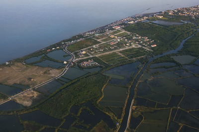 Aerial view of agricultural field by buildings