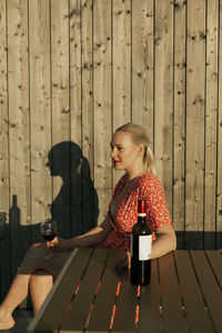 Woman drinking red wine on patio