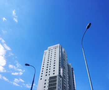 Low angle view of modern building against blue sky