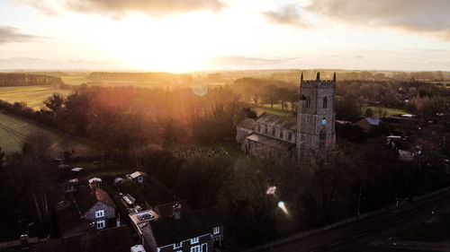 High angle view of illuminated buildings against sky at sunset