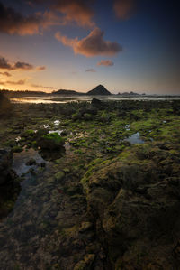 Scenic view of land against sky during sunset