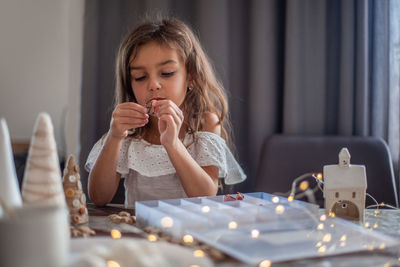 Girl sitting on table at home