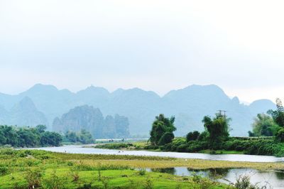 Scenic view of lake and mountains against sky