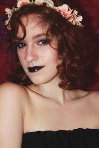 Close-up portrait of beautiful woman wearing flowers