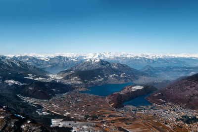 High angle view of snowcapped mountain against blue sky