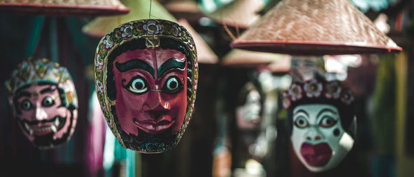 Close-up of sculptures hanging at market stall