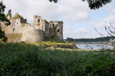 View of old ruin building against cloudy sky