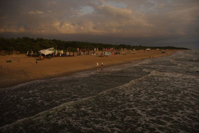 People on beach against sky