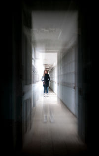 Man walking in corridor of building