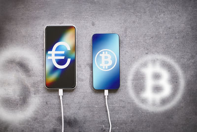 Charging phones with bitcoin and euro symbols