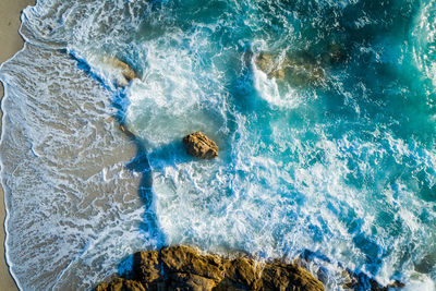 High angle view of water splashing on rocks