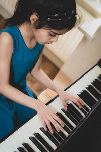 High angle view of girl playing piano