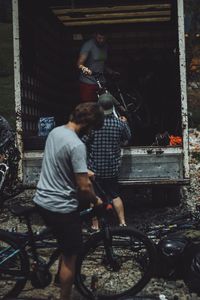 Rear view of men standing on street