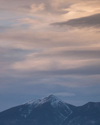 Scenic view of snowcapped mountains against sky during sunset