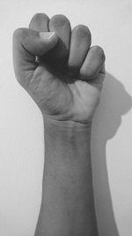 Close-up of human hand over white background