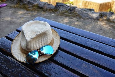 Hat and sunglasses on the bench