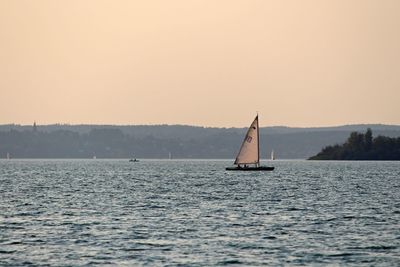 Sailboat sailing on sea against sky