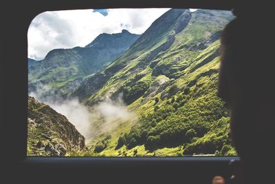 Scenic view of mountains against cloudy sky