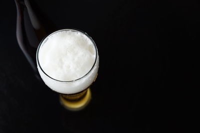 High angle view of beer glass against black background