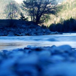 Surface level of frozen water on land against sky