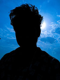 Low angle view of silhouette man against sky