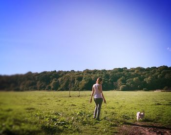 Rear view of woman standing on field