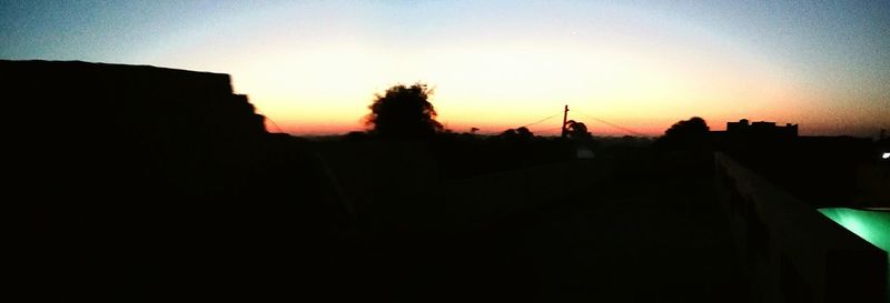 Silhouette of buildings against clear sky