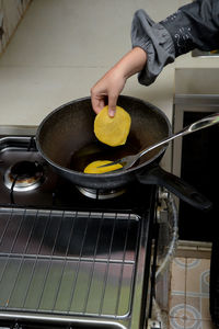 Midsection of man preparing food in kitchen