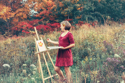 Full length of woman standing on field