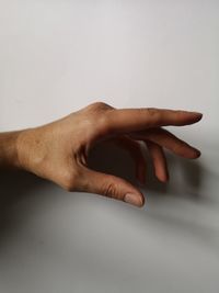 Close-up of hand against white background