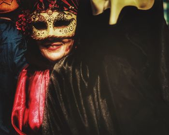 Close-up portrait of smiling woman with mask