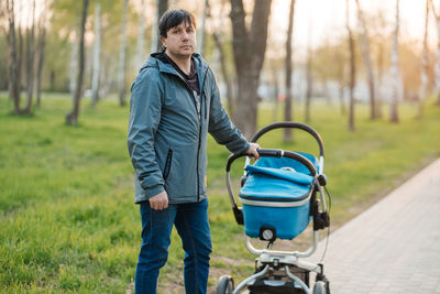 Dad with stroller walking in the park