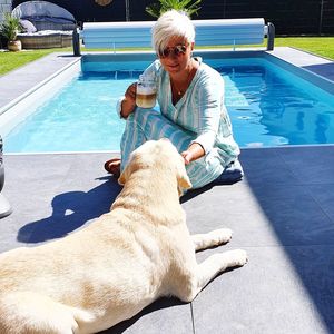 Man with dog in swimming pool