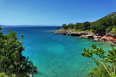 Scenic view of sea against clear blue sky