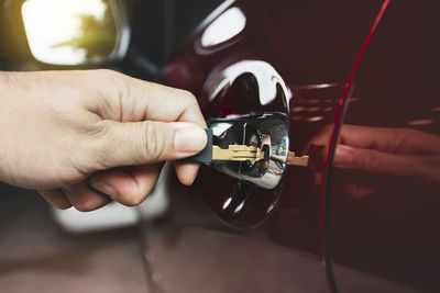 Close-up of person hand holding car