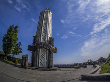 Low angle view of statue in city against sky