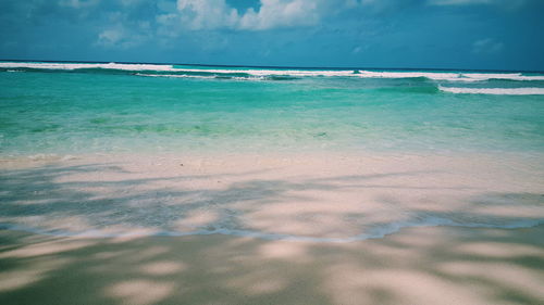 Scenic view of calm sea against blue sky