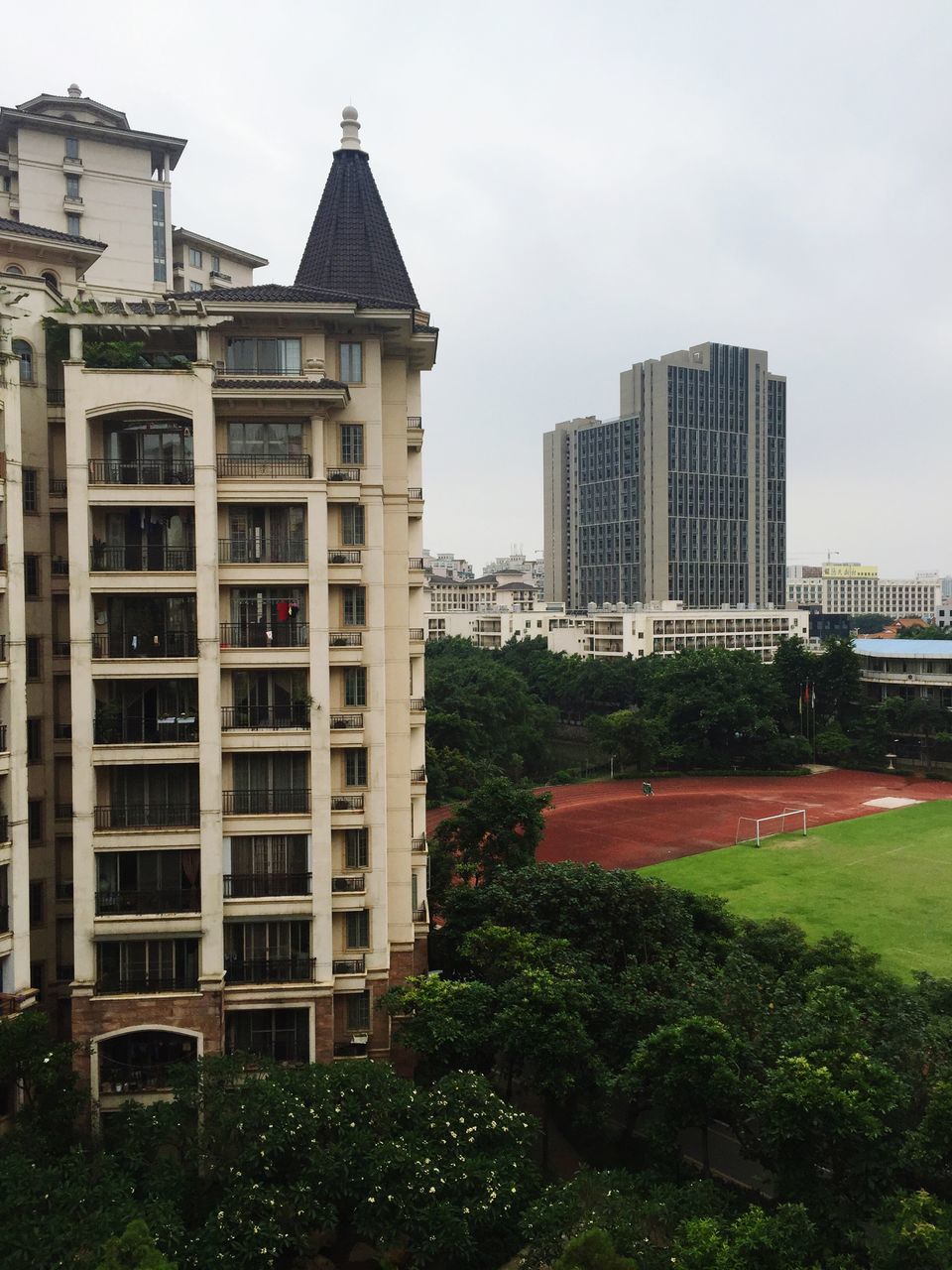building exterior, architecture, built structure, grass, city, sky, building, tree, lawn, residential building, growth, window, residential structure, day, green color, office building, outdoors, modern, plant, clear sky