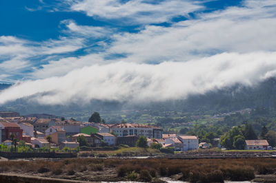 A sea of white clouds going down the mountains to the village of noia in galicia