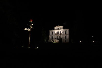 Illuminated building against sky at night