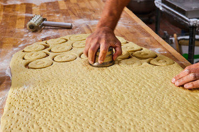 Cropped hand of person preparing food