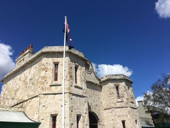 Low angle view of old building against blue sky