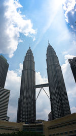 Low angle view of buildings against cloudy sky