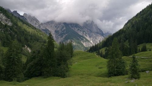 Scenic view of mountains against cloudy sky