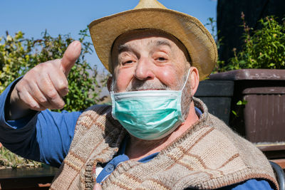 Portrait of man holding hat