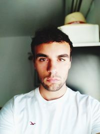 Close-up portrait of young man at home