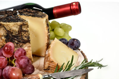 Close-up of fruits in plate against white background
