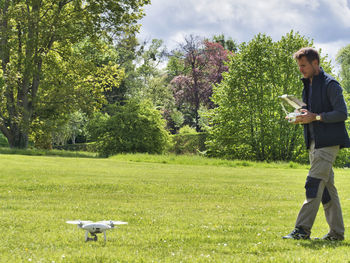 Full length of young man using mobile phone in park