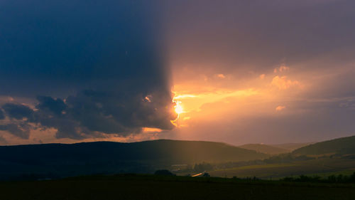 Scenic view of silhouette mountains against sky during sunset