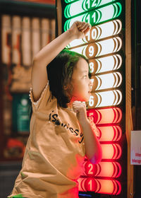 Cute girl looking at illuminated game